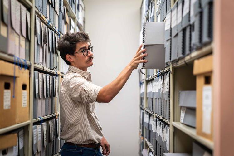 A student looks through material in the Pacific archives.