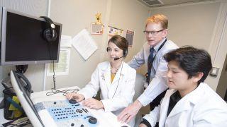 audiology professor and students in lab